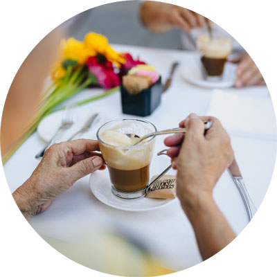 Elderly woman having coffee