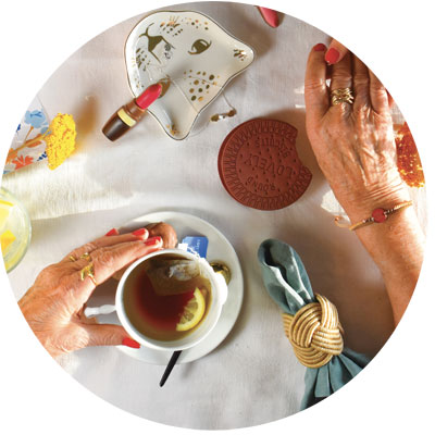 Grandmother enjoying cup of tea and a biscuit